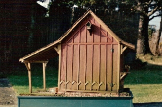 Hinged back wall with birdhouse